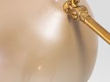 a gold ball with a golden handle on it