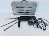 a drill that is sitting next to a tool box