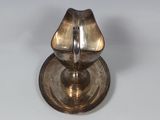 a silver plate with a candle holder on it