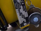a close up of a yellow suitcase with a tag on it