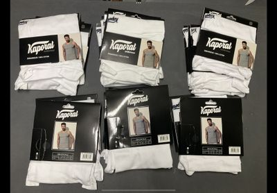 six pairs of men ' s white socks are on a table