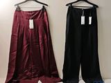 pair of women ' s pants hanging on a hanger in front of a white wall