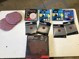 a lot of sanding discs and discs on a table