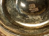 a gold plate with a tag on it
