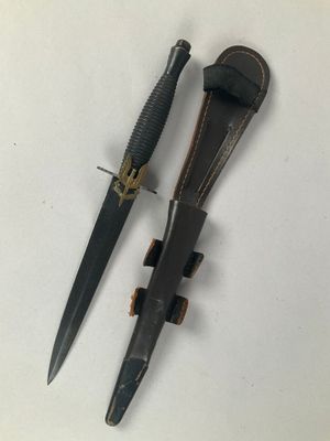 two knives are laying next to each other on a white surface