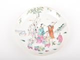 a plate with a painting on it on a white surface