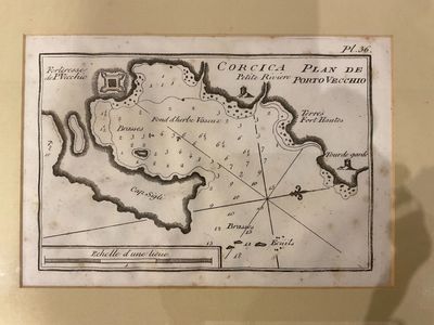 an old map on display in a glass case with a shadow of a person