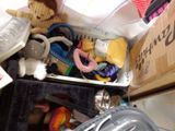 a pile of stuffed animals and other items in a box