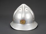 an old silver helmet with a gold emblem on it