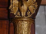 a golden bird on the top of a wooden column