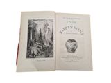 an open book with a picture of a man and a woman in a forest