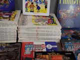 a lot of comic books that are on the table