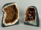 two pieces of geoglyite on a white surface with a white background