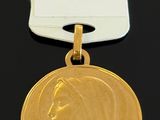 a close up of a gold medal with a tag on it