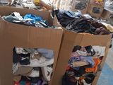 boxes of clothing are stacked on top of each other in a warehouse