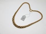 a close up of a gold necklace with a tag on it