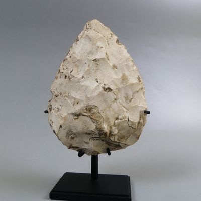 an image of a stone object on a black stand