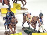 six figurines of men riding horses on display