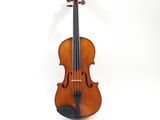an old violin sitting on top of a white surface