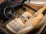 beige leather interior of a sports car with a steering wheel and dashboard