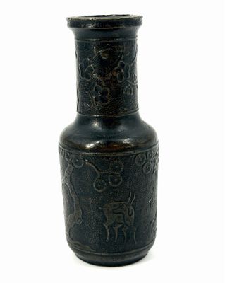 a black vase with a design on it on a white background
