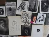 many pictures of people on the wall of a room