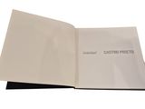 a close up of a book with a white cover and black pages