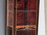 a small cabinet with a glass door on the outside