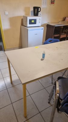 a table with a bottle of water on it in the kitchen
