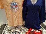 two women ' s shirts and a t - shirt sitting on a table next to each other