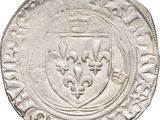 a close up of a coin with a coat of arms on it