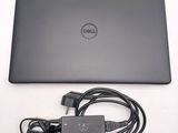 a dell laptop with a charger attached to it