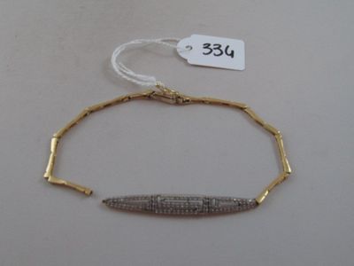 gold plated bracelet with a diamond bar on it and a price tag on the side