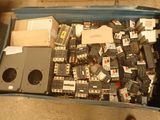 a blue box filled with electronic components and a person standing next to it