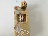 a small figurine of a cat in a box on a table