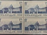 four stamps with a picture of a large building on them