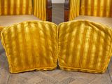 pair of yellow striped chairs sitting on top of a wooden floor