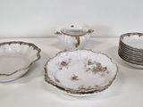 a white table topped with dishes and cups and saucers