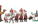 many figurines of knights and horses in a row