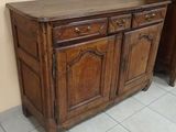 a wooden cabinet with two drawers on top of it