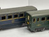 three toy trains sitting side by side on a white surface