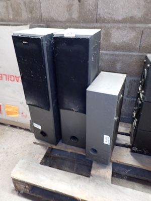 three speakers sitting on a pallet in front of a wall