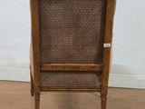 an old wooden chair with a woven seat and back rest