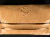 an image of a tan leather wallet with a logo on it