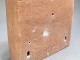 concrete planter with holes and holes in it on a gray surface
