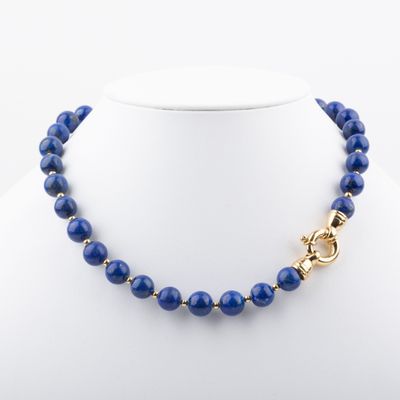a blue beaded necklace on a mannequin with a gold clasp