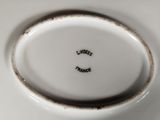 a close up of a white plate with a black writing on it
