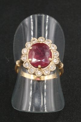an image of a ring with a red stone in it