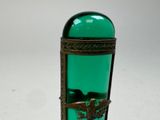 a green glass bottle with a bird on it