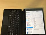 a tablet and a laptop sitting on a table